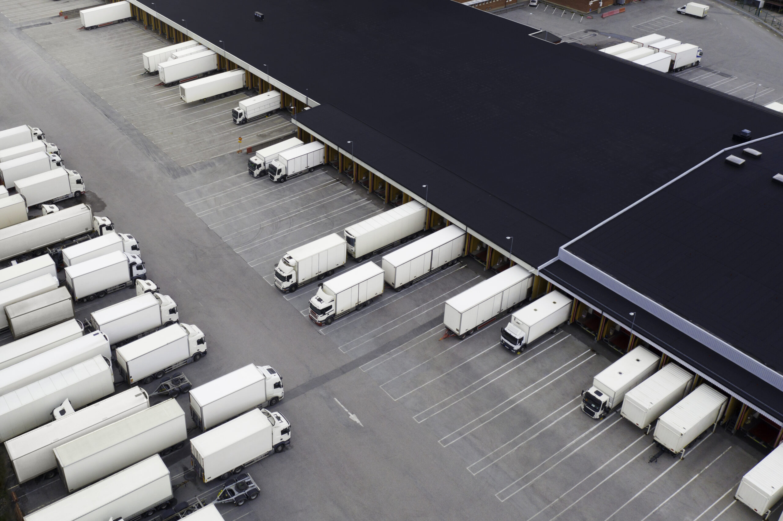 Large distribution center with many trucks viewed from above